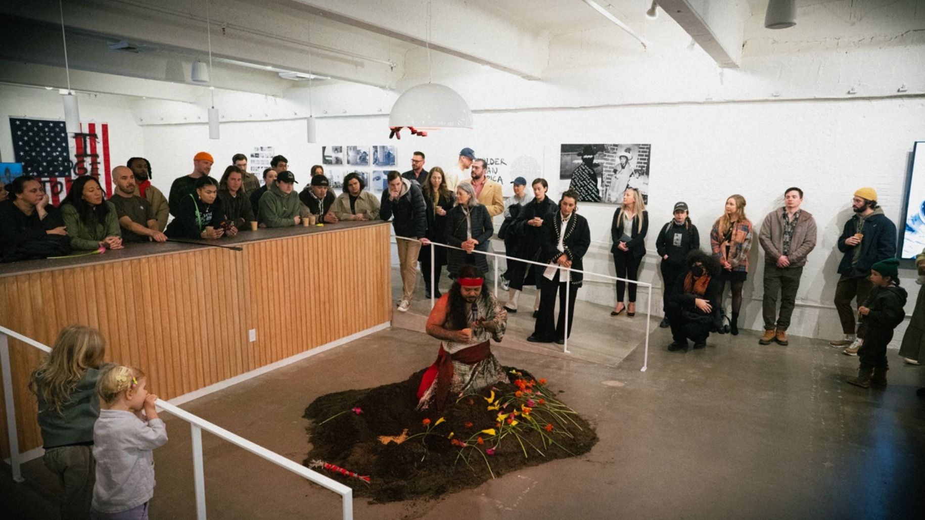 Josue rising from his exhibit burial with crowd behind him watching