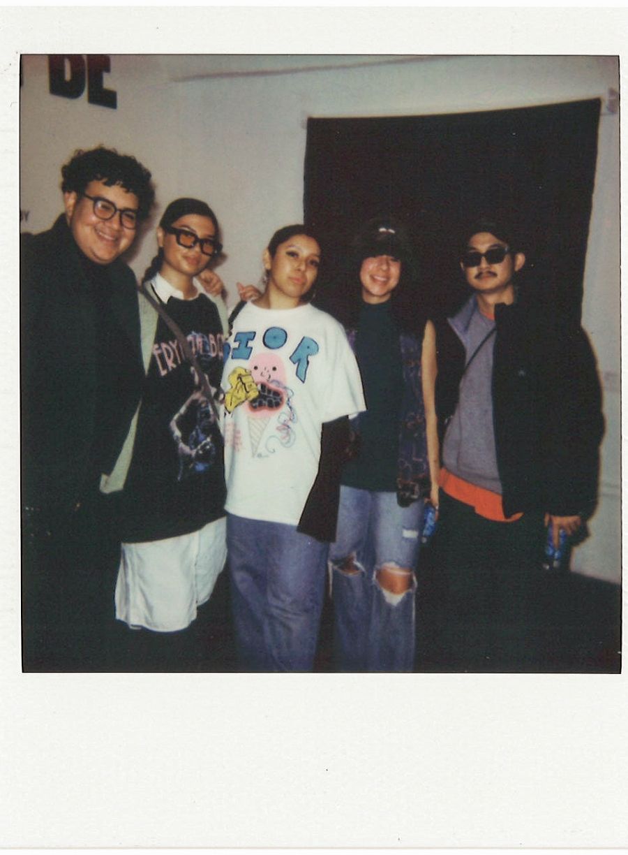 polaroid of 5 people posing at art gallery show