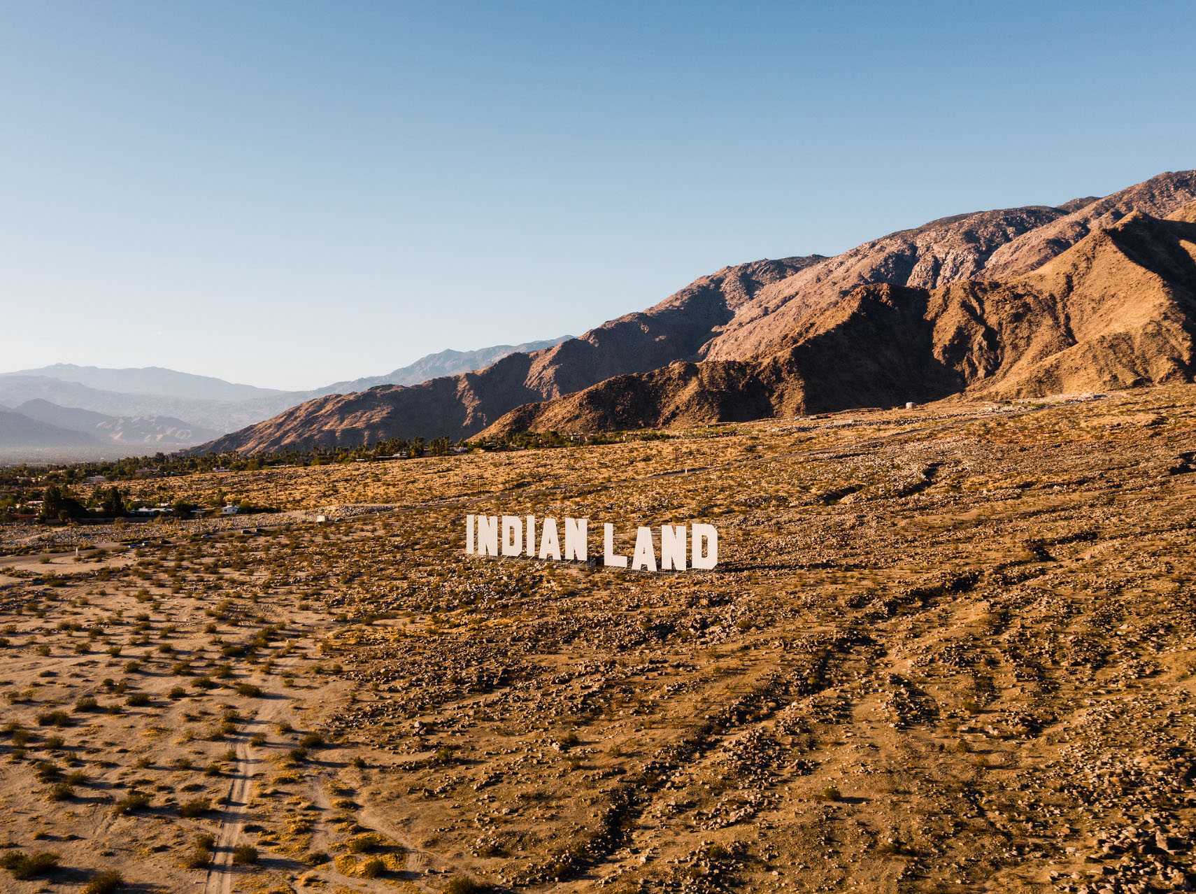 Indian Land sign in middle of desert.