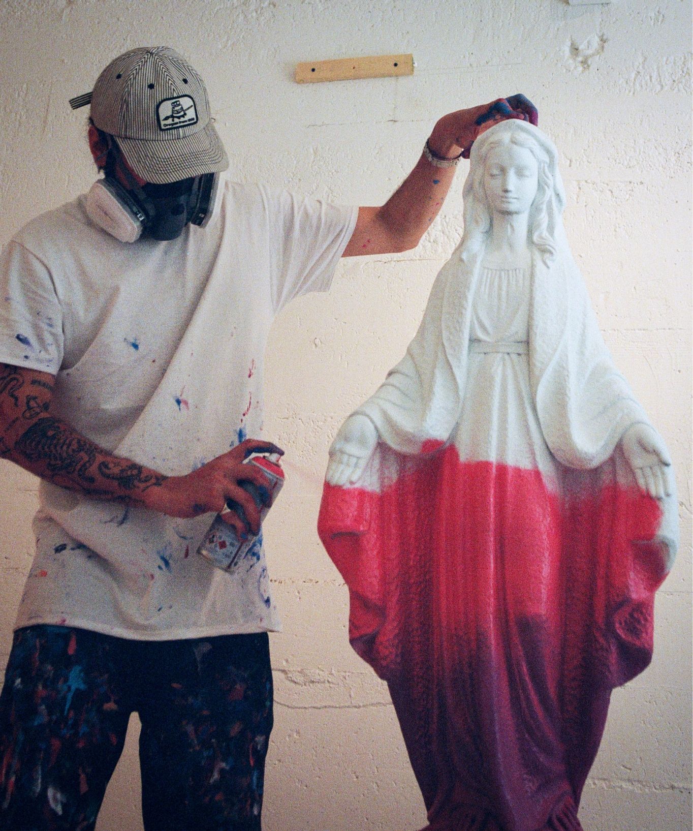 Its a Living spray painting a virgin Mary statue